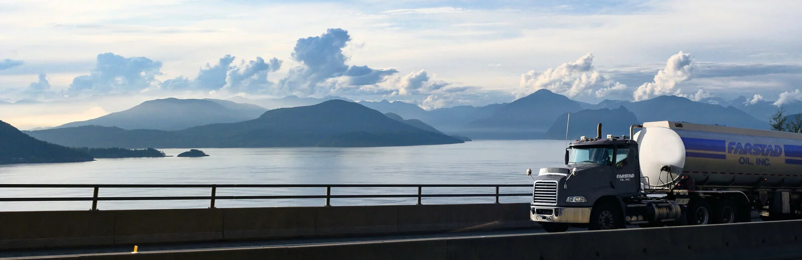 Farstad Oil fuel tanker driving with mountains and a lake in the background in the Northern USA.